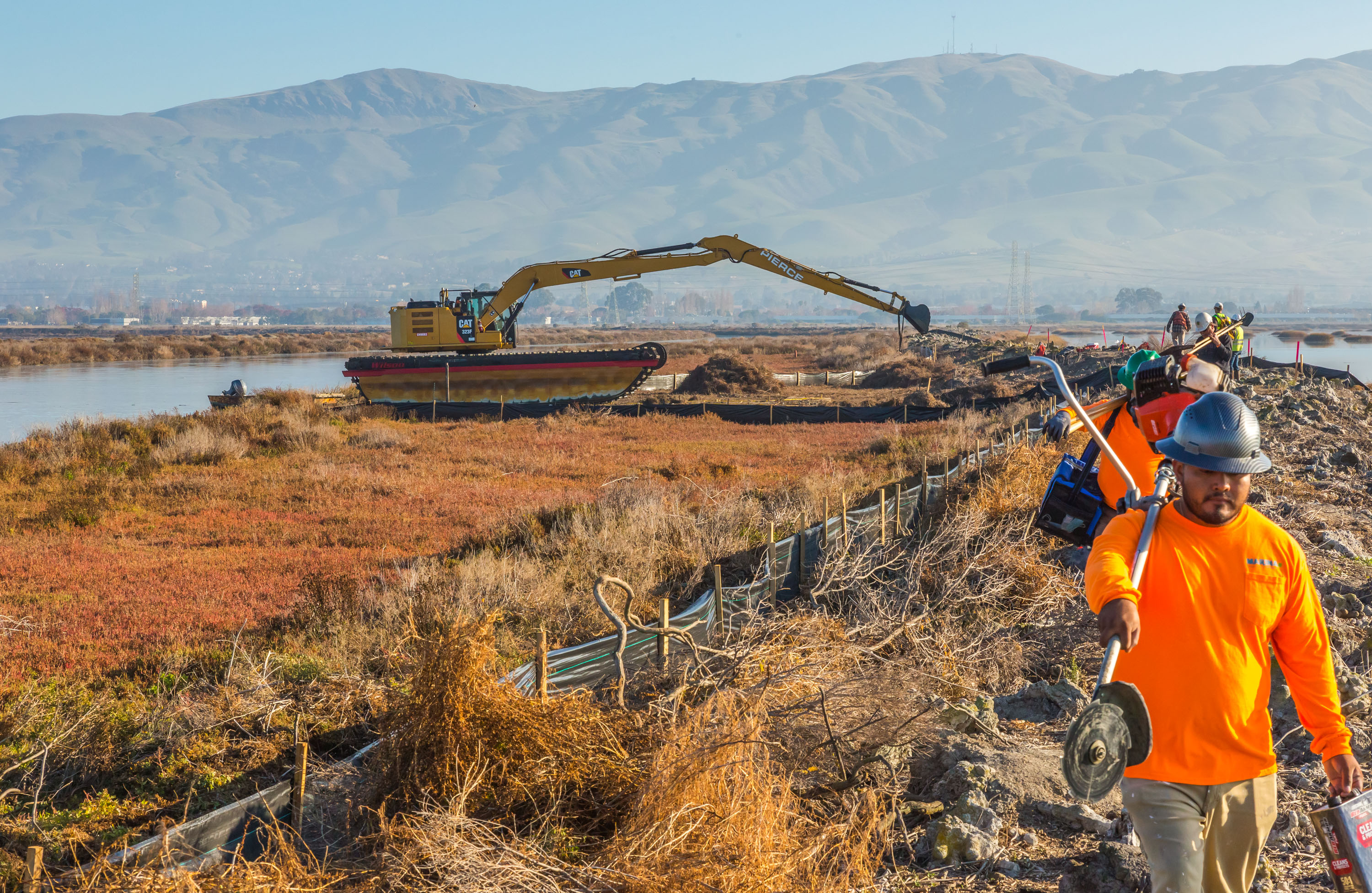 Busy workers and machines at the Island Ponds. Credit: Julie Kitzenberger