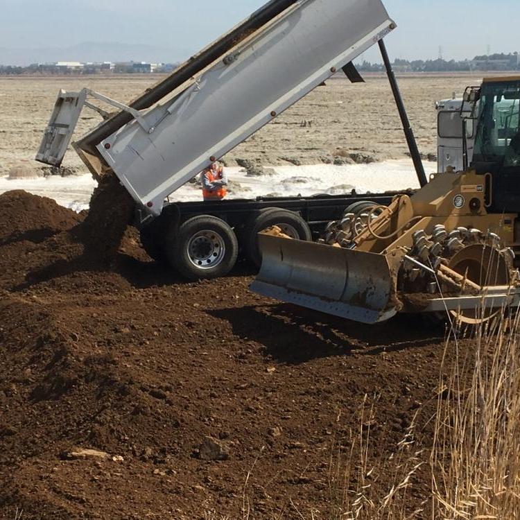 Dirt is delivered and smoothed at Ravenswood Pond R4, which will become salt marsh with an upland habitat bordering Menlo Park's Bedwell Bayfront Park.