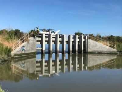 Juan Flores of the U.S. Fish and Wildlife Service's Don Edwards Refuge lifts the last of the eight gates on the Pond A8 dam.