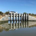 Juan Flores of the U.S. Fish and Wildlife Service's Don Edwards Refuge lifts the last of the eight gates on the Pond A8 dam.