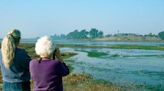 Two people watching wetland birds. Credit: Michael Peters